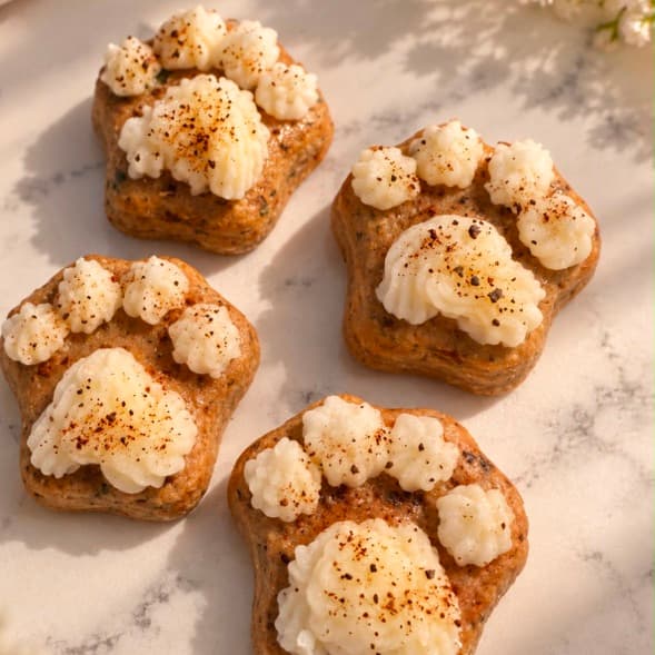 Mini pawcakes: paw-shaped dog biscuits topped with swirls of cream icing